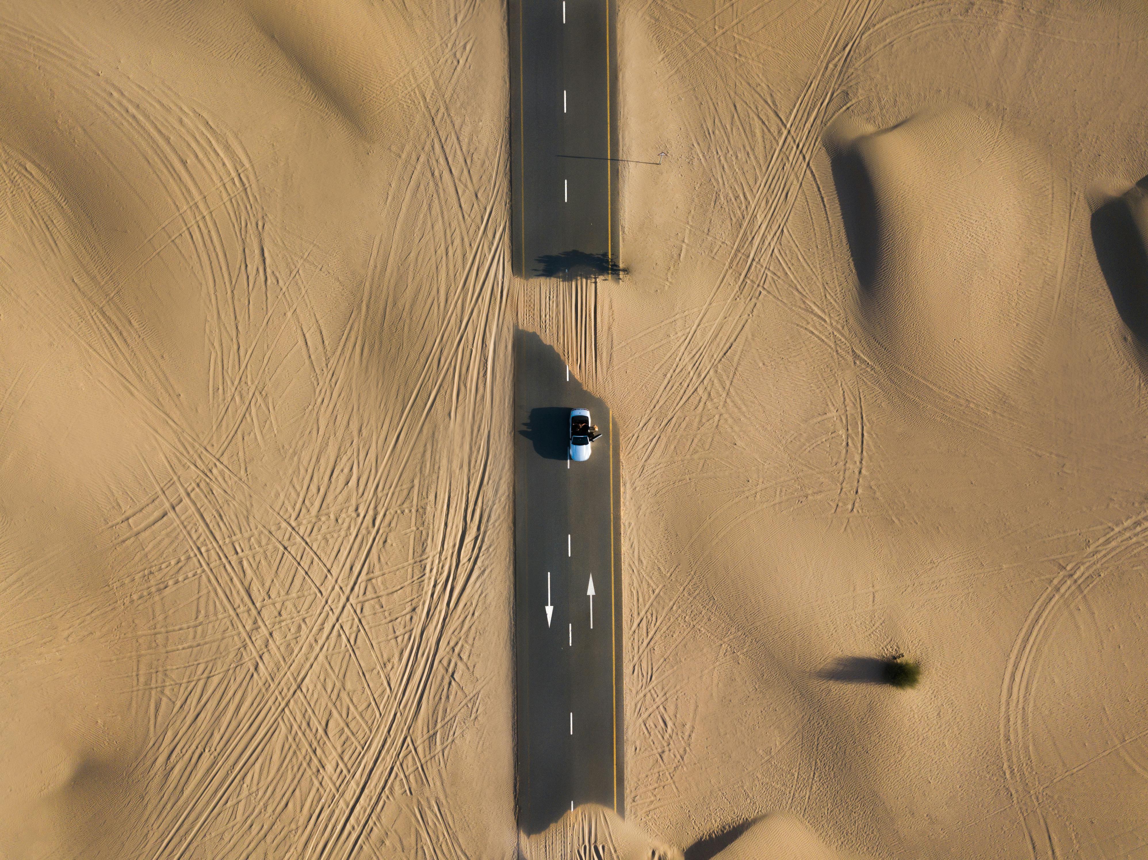 Cars cruising through a desert