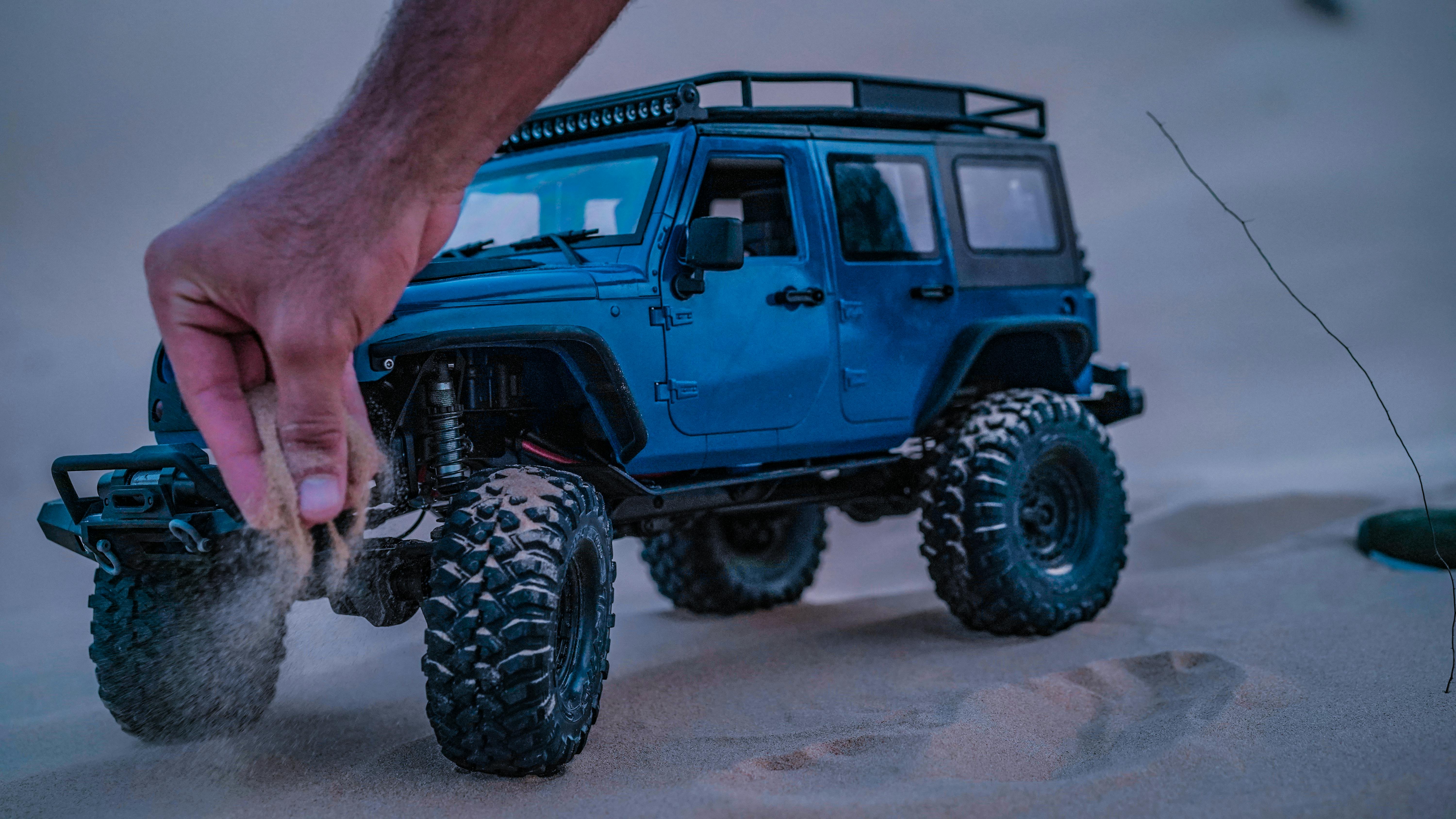 A toy car close-up shot while cruising a desert